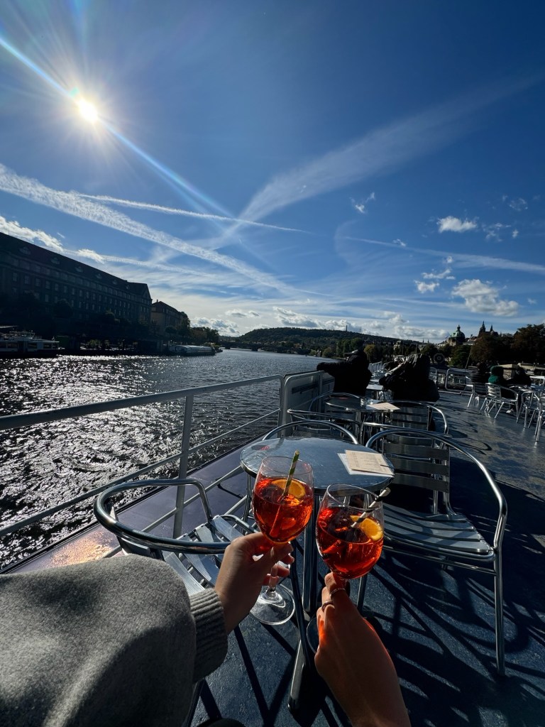Clinking glasses on a river boat cruise in Prague
